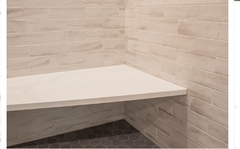 Built-in tiled shower bench in a spa-inspired bathroom remodel